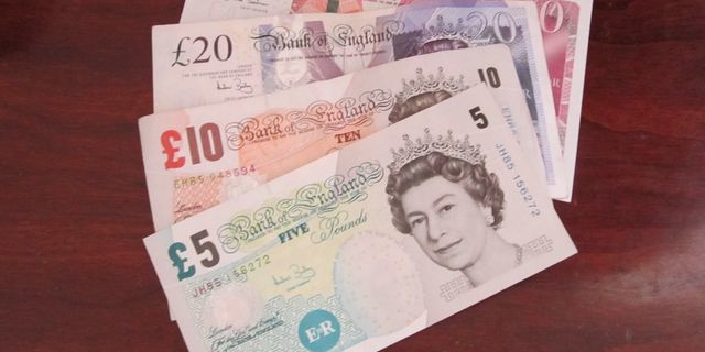 Sterling pares revenues on revised UK GDP 